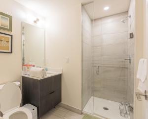 a bathroom with a shower and a toilet and a sink at Bisco Hill in Richmond Hill +18 photos