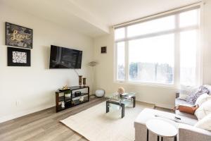 a living room with a couch and a tv at Bisco Hill in Richmond Hill