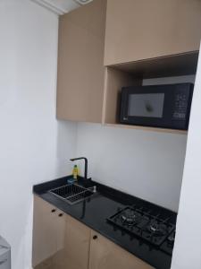 a kitchen with a stove and a microwave at OD-VICK'S PLUSH STUDIOS, Utako in Abuja +38 photos