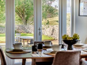 a dining room with a table and a large window at 5 Bed in Dunbar oc-94334 in Dunbar