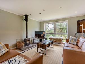 a living room with a couch and a fireplace at 5 Bed in Dunbar oc-94334 in Dunbar