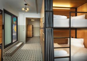 a dorm room with bunk beds and a hallway at Hostal CASA MX centro in Mexico City