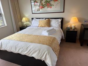 a bedroom with a large bed with two night stands at As You Wish Suites & Rooms Near YVR with Parking in Richmond