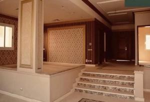 a lobby with stairs in a building with a door at Katameya Palms in Cairo