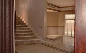a staircase in a room with a window and a stair case at Katameya Palms in Cairo