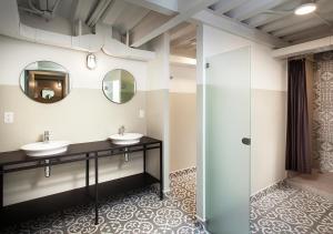 a bathroom with two sinks and a mirror at Hostal CASA MX centro in Mexico City