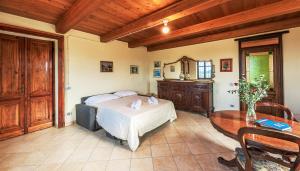 a bedroom with a bed and a wooden ceiling at Villa Bricco Paglieri in Alba