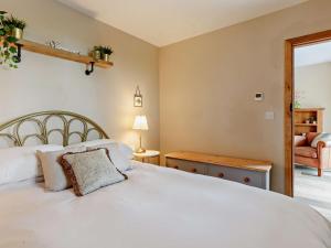 a bedroom with a white bed and a chair at 2 Bed in Wells oc-90425 in Croscombe