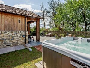 a hot tub in a yard next to a building at 2 Bed in Wells oc-90425 in Croscombe +7 photos