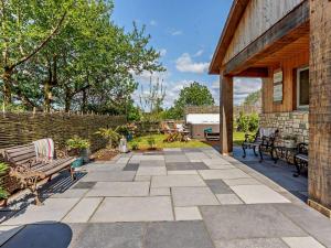 a patio with benches and a brick building at 2 Bed in Wells oc-90425 in Croscombe