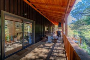 a covered porch of a house with a wooden ceiling at Tiny & Big House Suite Los Mallines de Malalcahuello in Malalcahuello