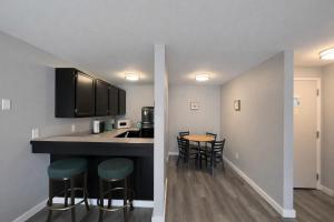 a kitchen with a counter and a table and chairs at Friday Harbor Suites in Friday Harbor