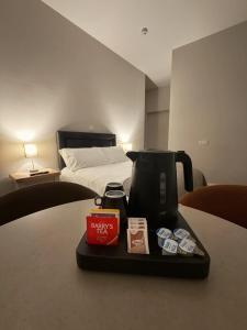 a coffee maker on a tray on a table next to a bed at Wild Atlantic Inn in Lisdoonvarna