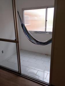 a room with a hammock in the corner of a room at Apartamento em Pelotas Centro in Pelotas +13 photos