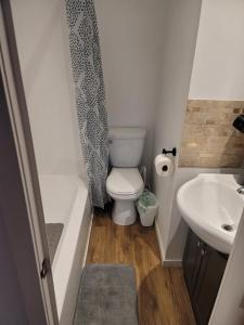 a small bathroom with a toilet and a sink at Warm cozy 1 bdrm close to Hwy in Edmundston +14 photos