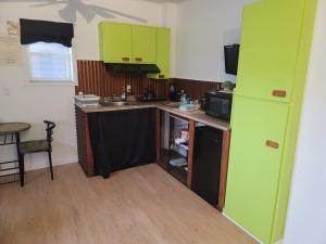 a kitchen with green cabinets and a counter top at Warm cozy 1 bdrm close to Hwy in Edmundston