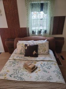 a bed with a blanket and a tray on it at Warm cozy 1 bdrm close to Hwy in Edmundston
