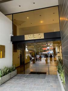a lobby of a building with a large glass door at Suites Edificio Akros in Quito