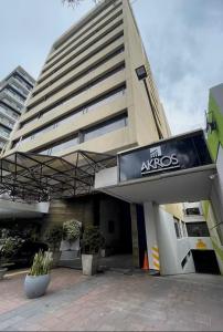 a large building with a sign in front of it at Suites Edificio Akros in Quito +6 photos