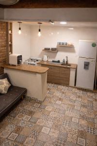 a kitchen with a white refrigerator and a counter at Duplex Mi Lar in Termas de Río Hondo