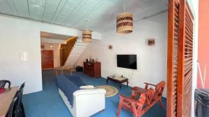 a living room with a bed and a tv at Casa Mandala Canoa Quebrada in Aracati