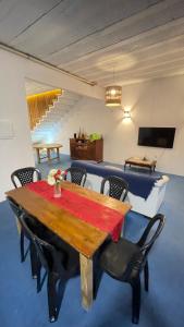 a dining room with a wooden table and chairs at Casa Mandala Canoa Quebrada in Aracati
