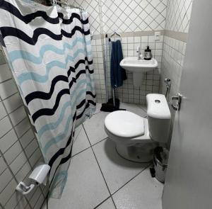 a bathroom with a toilet and a sink at Ap FIG Garanhuns in Garanhuns