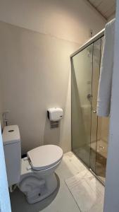 a bathroom with a toilet and a shower at Biribandos Rooms - a 300 metros do Quadrado e 900 metros das praias in Trancoso +46 photos