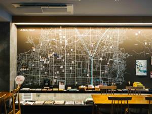 a mural of a subway map on the wall of a restaurant at KéFU stay & lounge in Kyoto