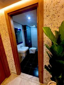 a bathroom with a sink and a toilet and a mirror at Residance Panorama 52 in Sousse