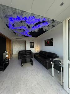 a living room with couches and a painting on the ceiling at Residance Panorama 52 in Sousse