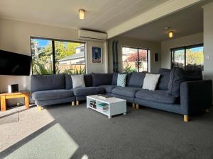 a living room with a blue couch and a table at Blue Lake Lodge - Lake Tekapo in Lake Tekapo