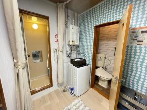 a small bathroom with a toilet and a shower at サイプレス平岸 in Sapporo +182 photos