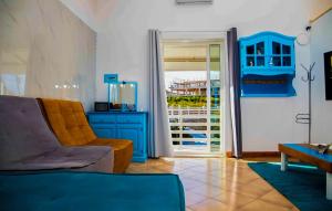 a living room with a couch and a blue cabinet at Villa Sara in Ragusa