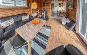 a living room with a couch and a table at Nice Home In Broager With Wifi in Broager