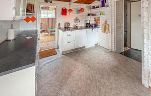 a kitchen with white cabinets and a counter top at Nice Home In Broager With Wifi in Broager