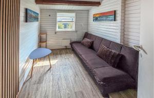 a living room with a couch and a table at Nice Home In Broager With Wifi in Broager