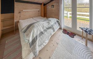 a bedroom with a bed in a room with a window at Nice Home In Broager With Wifi in Broager +9 photos
