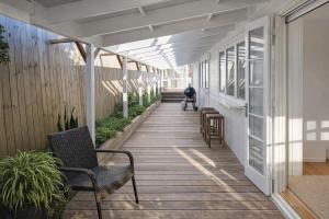 a hallway of a house with a person in a wheelchair at Raglan West Cottage, Surf Side Escape in Raglan