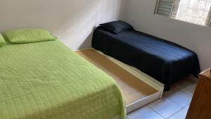 a small bedroom with a bed and a bed sidx sidx sidx at Casa Versátil in Ribeirão Preto