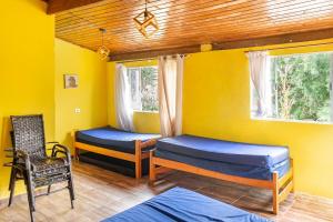 a room with two beds and a chair and a window at Chácara lar e paz Mairinque in Mairinque +37 photos