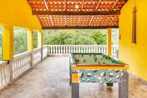 a pool table on a covered porch with a roof at Chácara lar e paz Mairinque in Mairinque