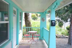 a porch with two chairs and a table on it at Mt Shasta Basecamp in Dunsmuir