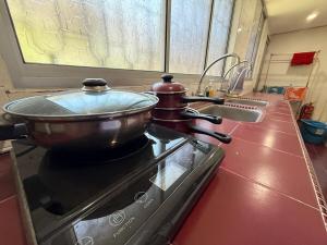 a pot on top of a stove in a kitchen at Ipoh Garden 4BR 10Pax in Ipoh +28 photos