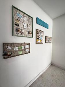 a wall with pictures and photographs on a wall at Ipoh Garden 4BR 10Pax in Ipoh