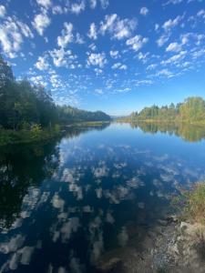 a river with reflections of clouds in the water at Lake Room in Sandpoint +12 photos