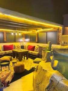 a room with a pool and a couch and a table at Ocean Breeze Guest House in Tamraght Ouzdar