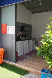 an open garage with a kitchen in it at Sơn Hà homestay in Ấp Bình Hưng