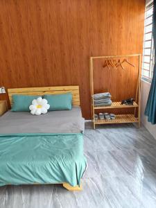 a bedroom with a bed with a flower on it at Sơn Hà homestay in Ấp Bình Hưng