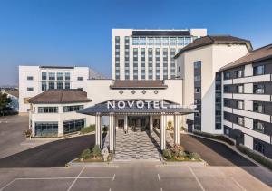 a view of a hotel with a nolect sign in a parking lot at Novotel Changshu Yushan in Changshu